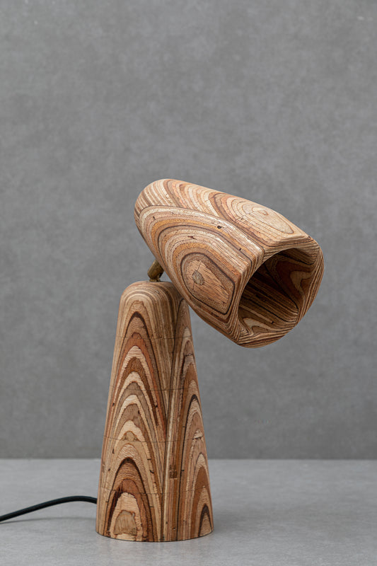 Wooden lamp with a unique grain pattern on a gray background