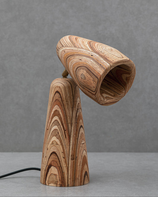 Wooden lamp with a unique grain pattern on a gray background