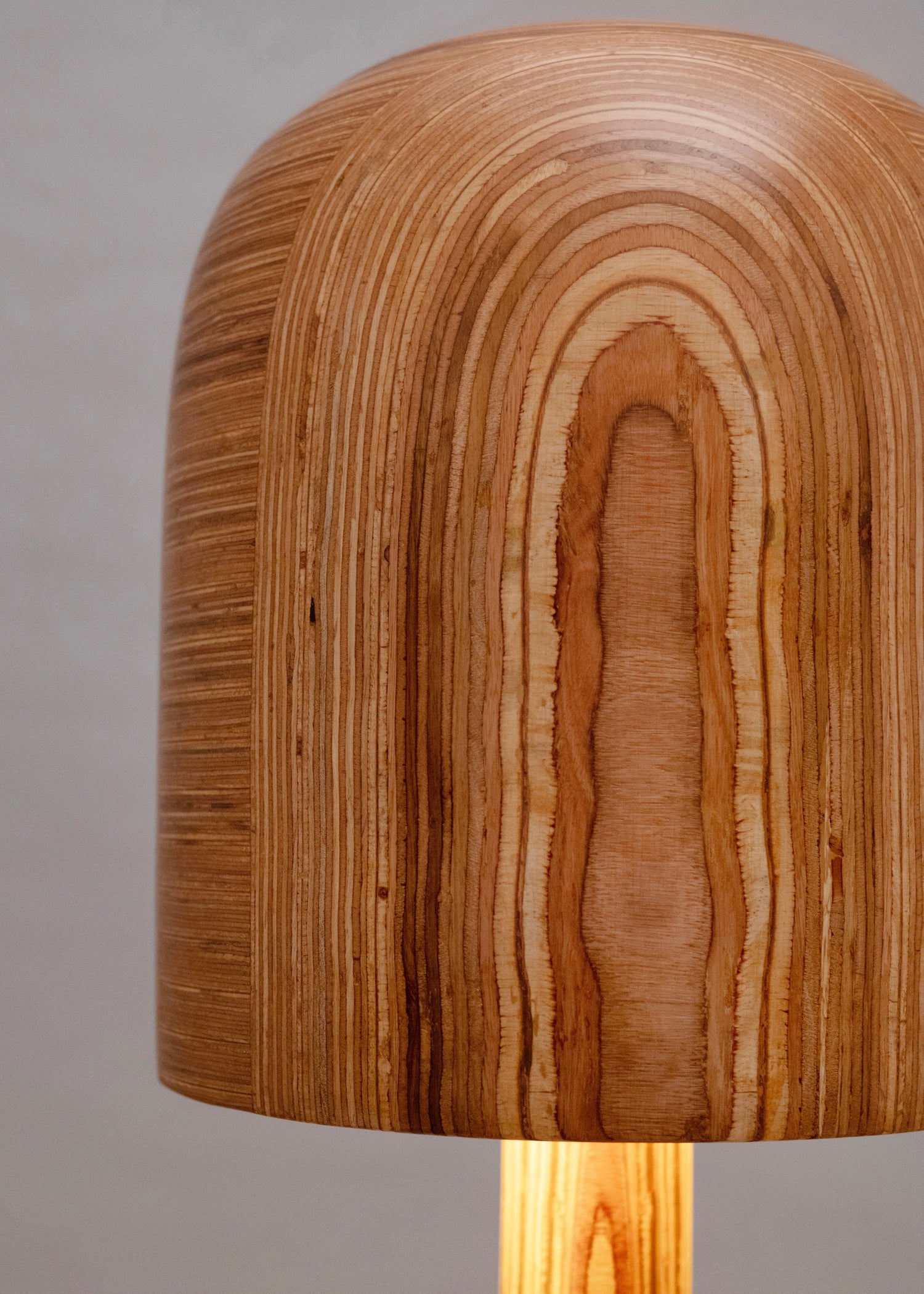 Wooden lamp with a textured shade on a neutral background