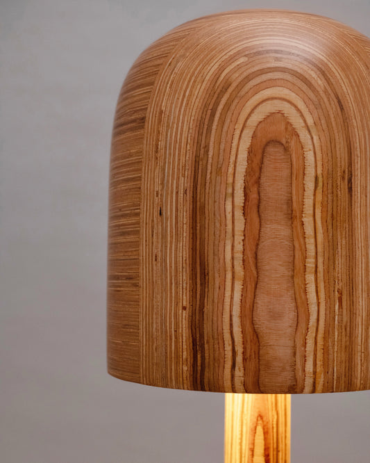 Wooden lamp with a textured shade on a neutral background